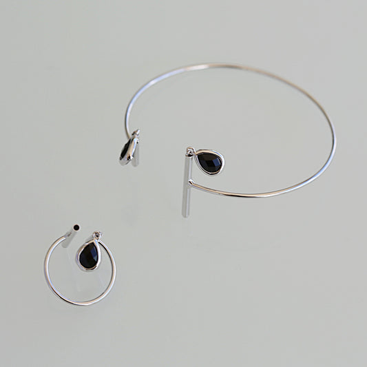 Half moon bangle with 2 black crystal charms