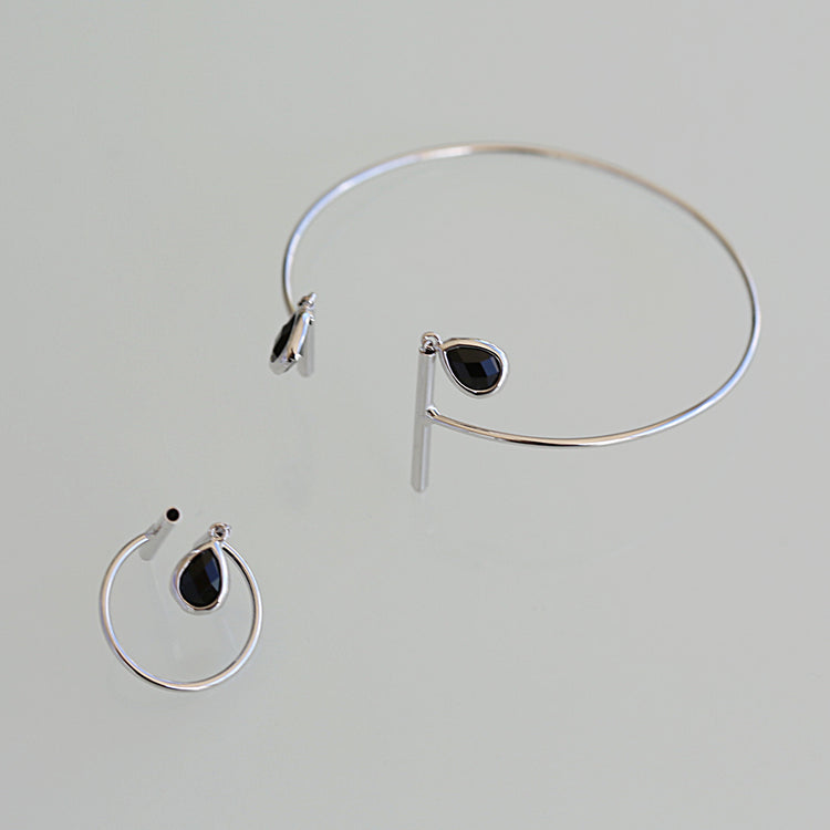 Half moon bangle with 2 black crystal charms